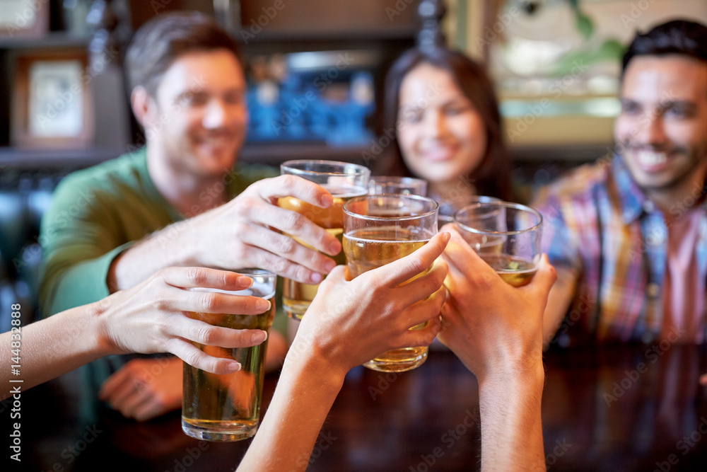 happy friends drinking beer at bar or pub happy friends drinking beer at bar or pub