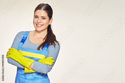 Portrait of smiling woman dressed cleaner uniform with crossed arms. photo