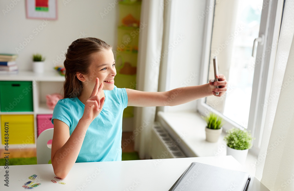 happy girl with smartphone taking selfie at home happy girl with smartphone taking selfie at home