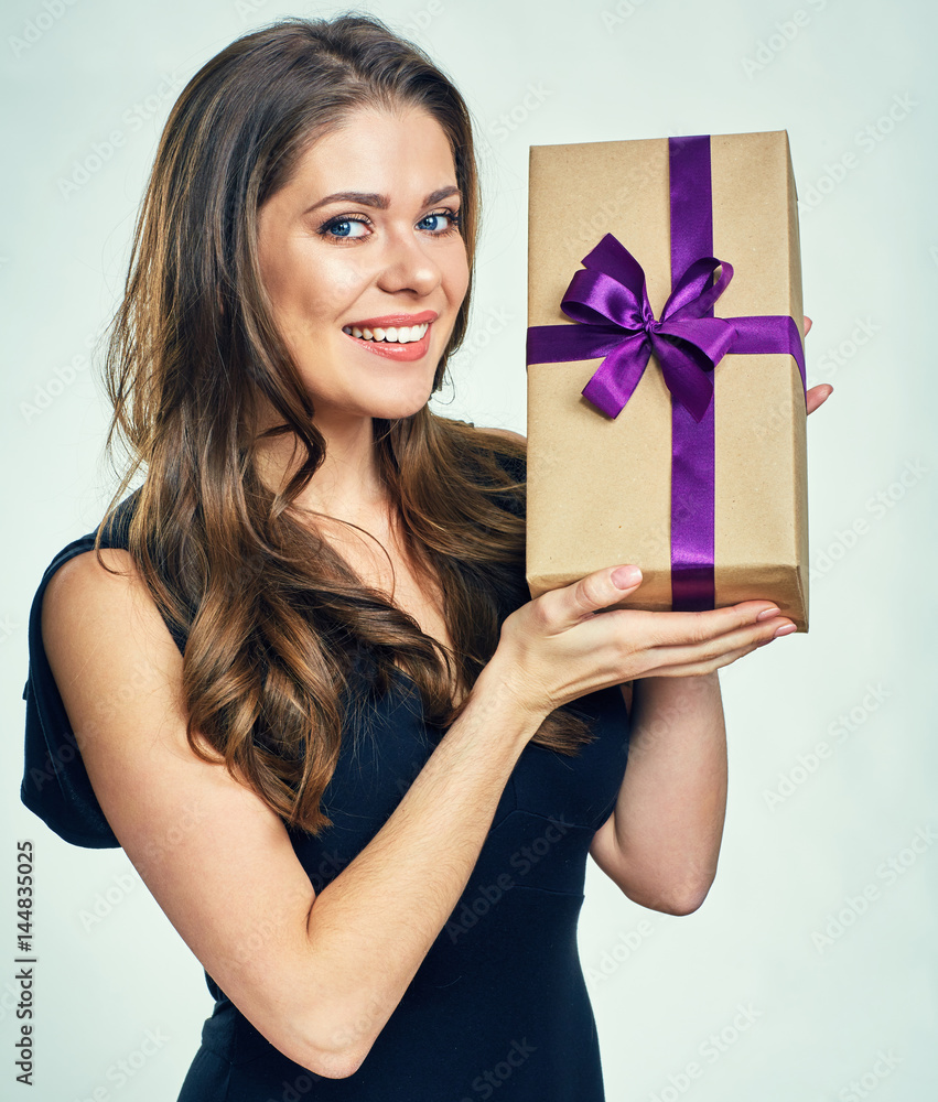 Smiling woman in black evening dress holding gift box. Smiling woman in black evening dress holding gift box.