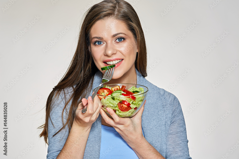 Young woman eating vegetarian salad