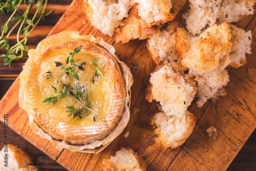 French baked Camembert cheese with thyme and baguette bread