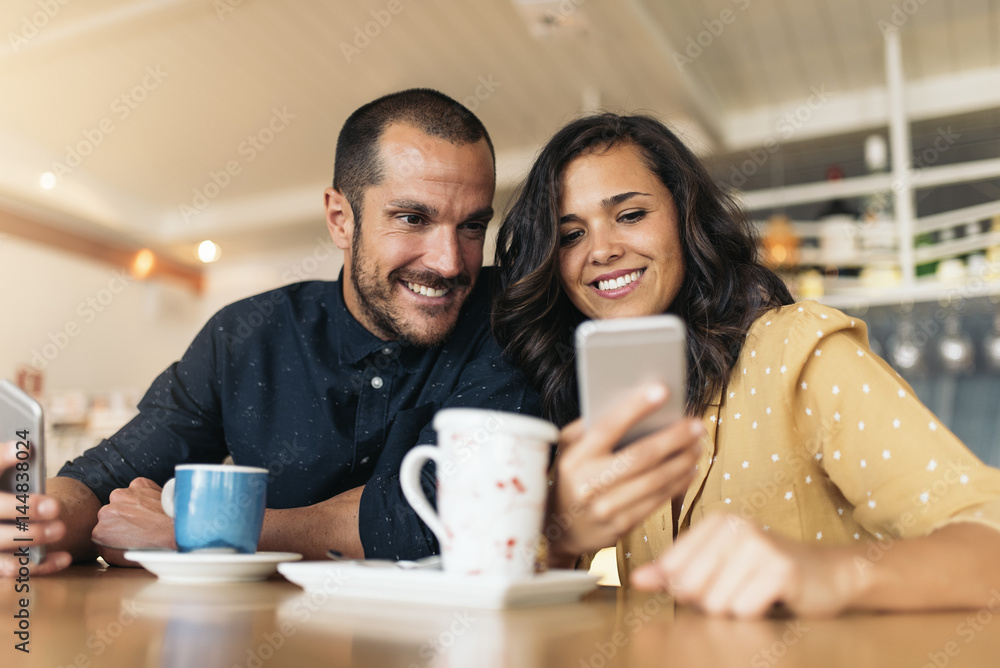 Happy friends using mobile. Happy friends using mobile.