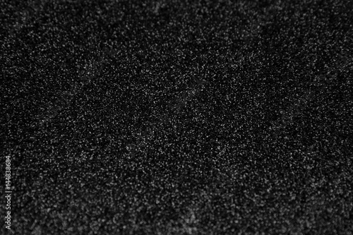 Black glitter background. Abstract shiny texture.
