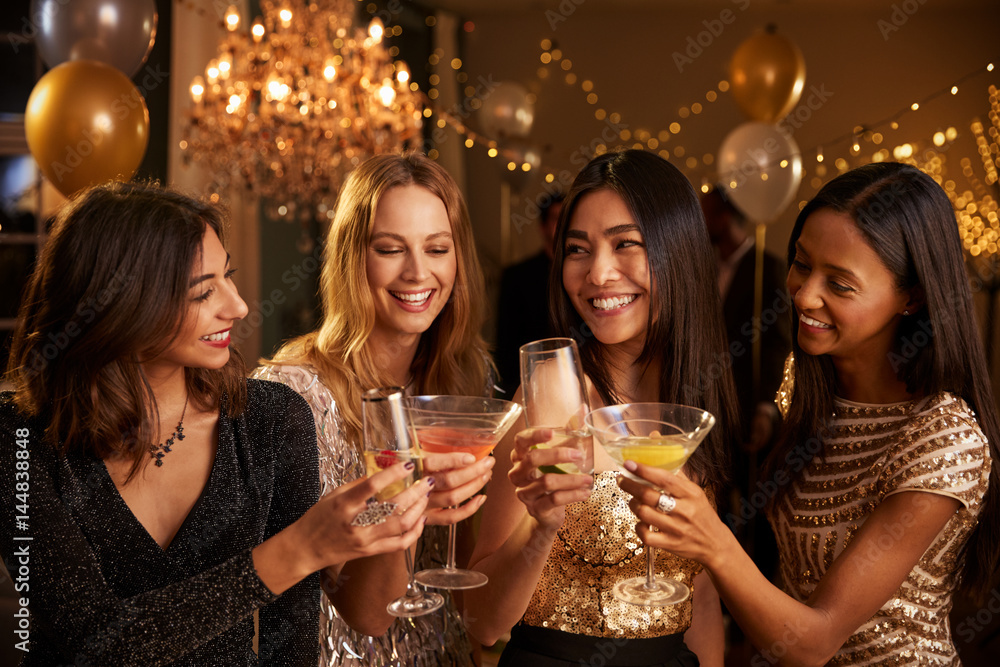 Female Friends Make Toast As They Celebrate At Party Female Friends Make Toast As They Celebrate At Party