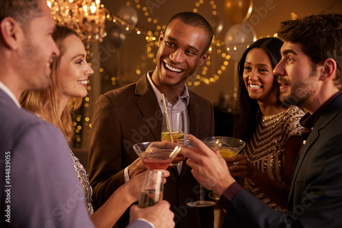 Group Of Friends With Drinks Enjoying Cocktail Party