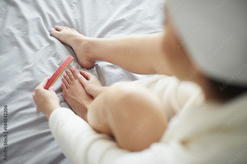 High angle view of woman filling nails High angle view of woman filling nails