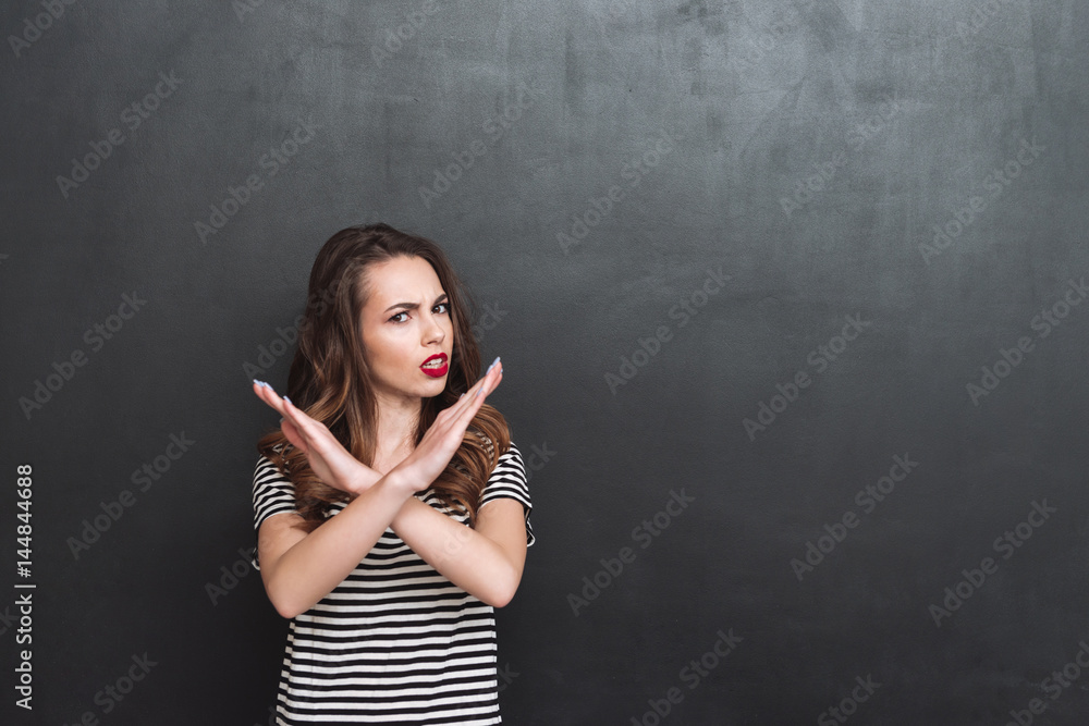 Displeased woman showing stop gesture Displeased woman showing stop gesture