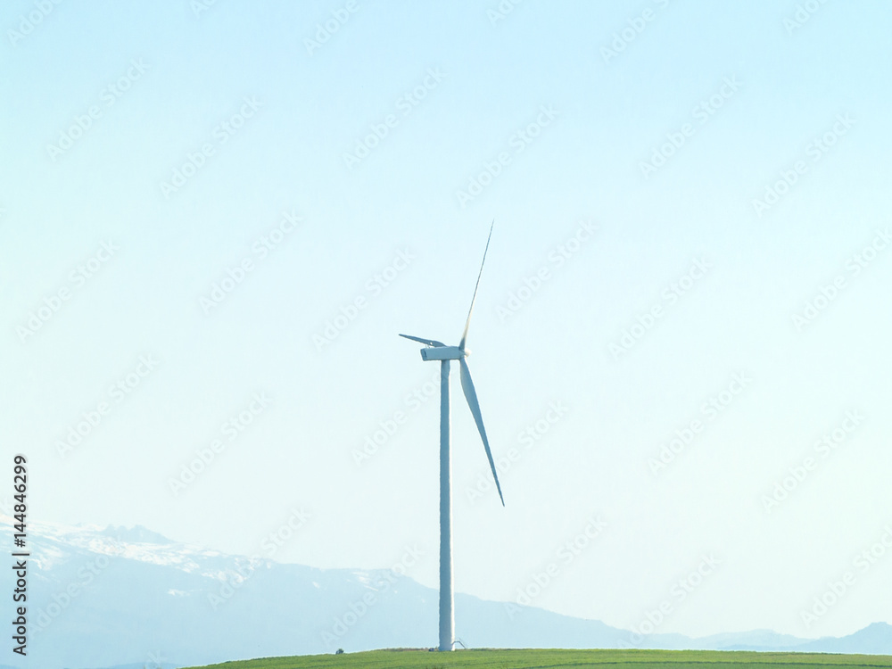 Windmill on countryside generating wind energy