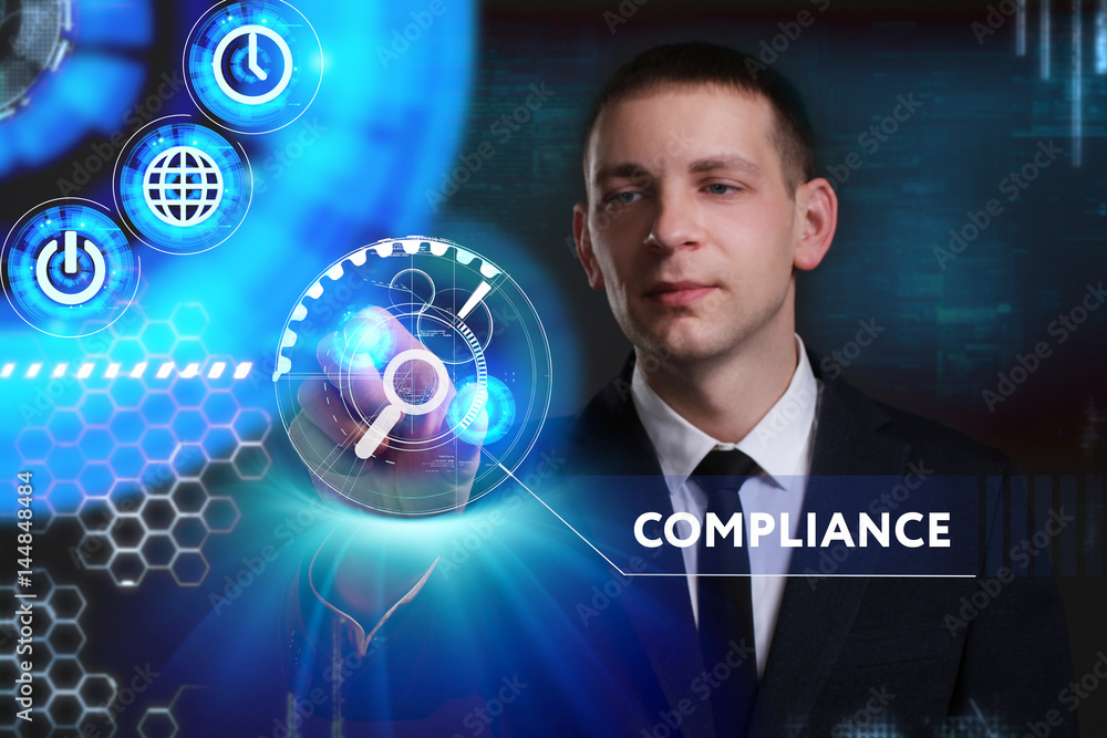 Business, Technology, Internet and network concept. Young businessman working on a virtual screen of the future and sees the inscription: Compliance Business, Technology, Internet and network concept. Young businessman working on a virtual screen of the future and sees the inscription: Compliance
