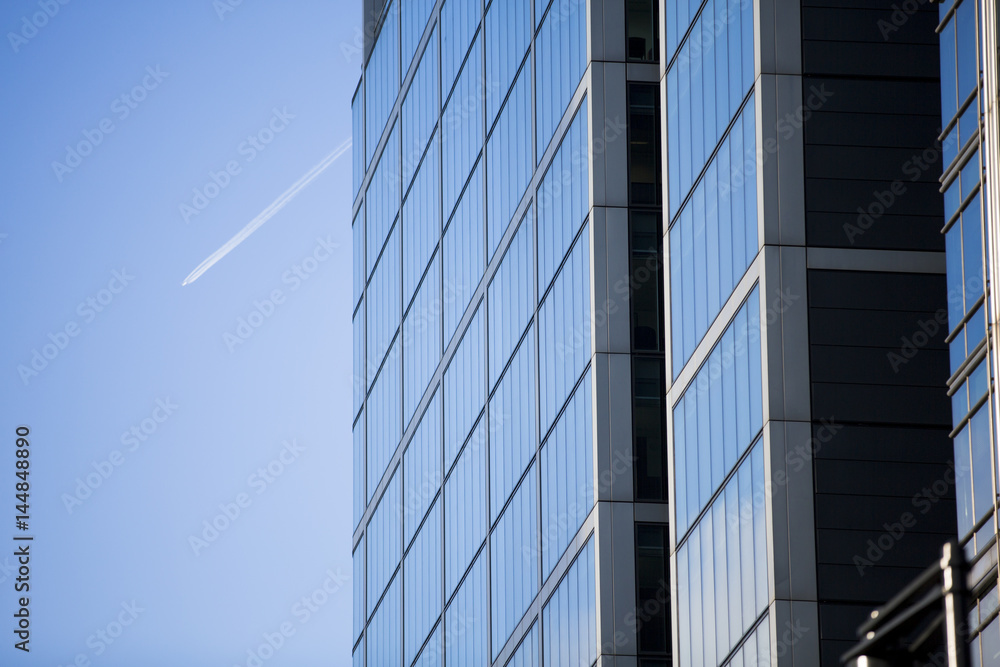 Perspective and underside angle view to textured background of modern glass building skyscrapers Perspective and underside angle view to textured background of modern glass building skyscrapers