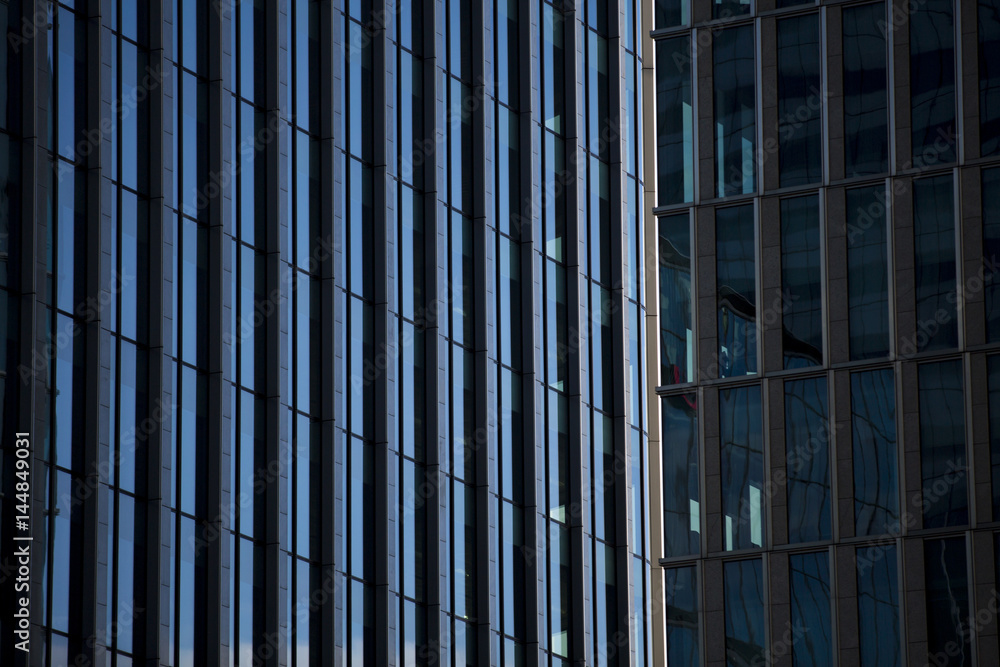 Perspective and underside angle view to textured background of modern glass building skyscrapers Perspective and underside angle view to textured background of modern glass building skyscrapers