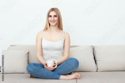 Beautiful young woman watching television