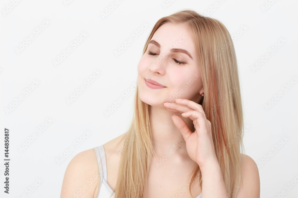 Closeup portrait of a beautiful young blond woman with clean face Closeup portrait of a beautiful young blond woman with clean face
