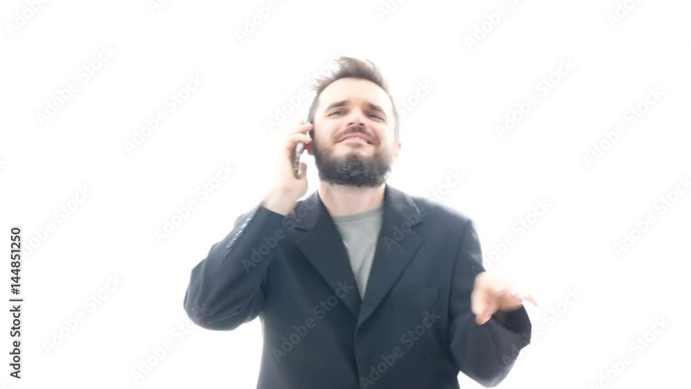 Excited successful bearded businessman on the phone gesturing, hi-key studio isolated on white background. Excited successful bearded businessman on the phone gesturing, hi-key studio isolated on white background.