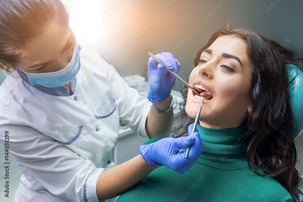 Dentist lady at work. Probe and mouth mirror. Dentist lady at work. Probe and mouth mirror.