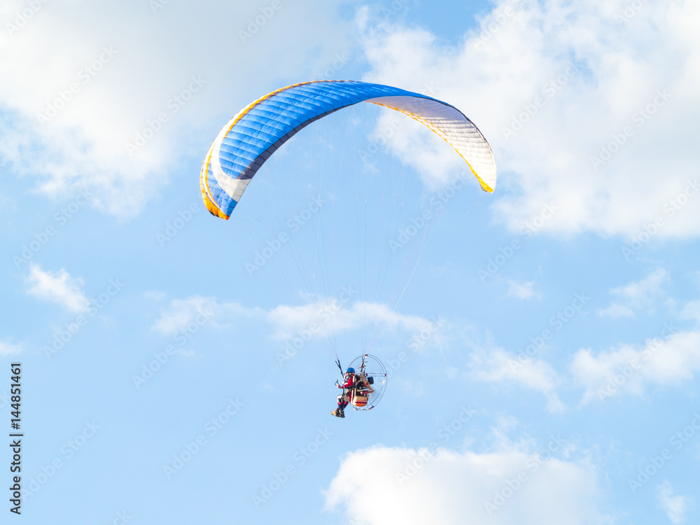 A man practicing extreme sport with paraglider with motor A man practicing extreme sport with paraglider with motor