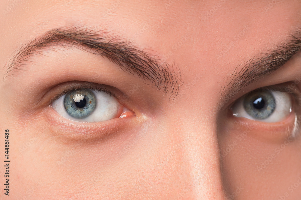 Fototapeta premium Beautiful blue man eyes close up