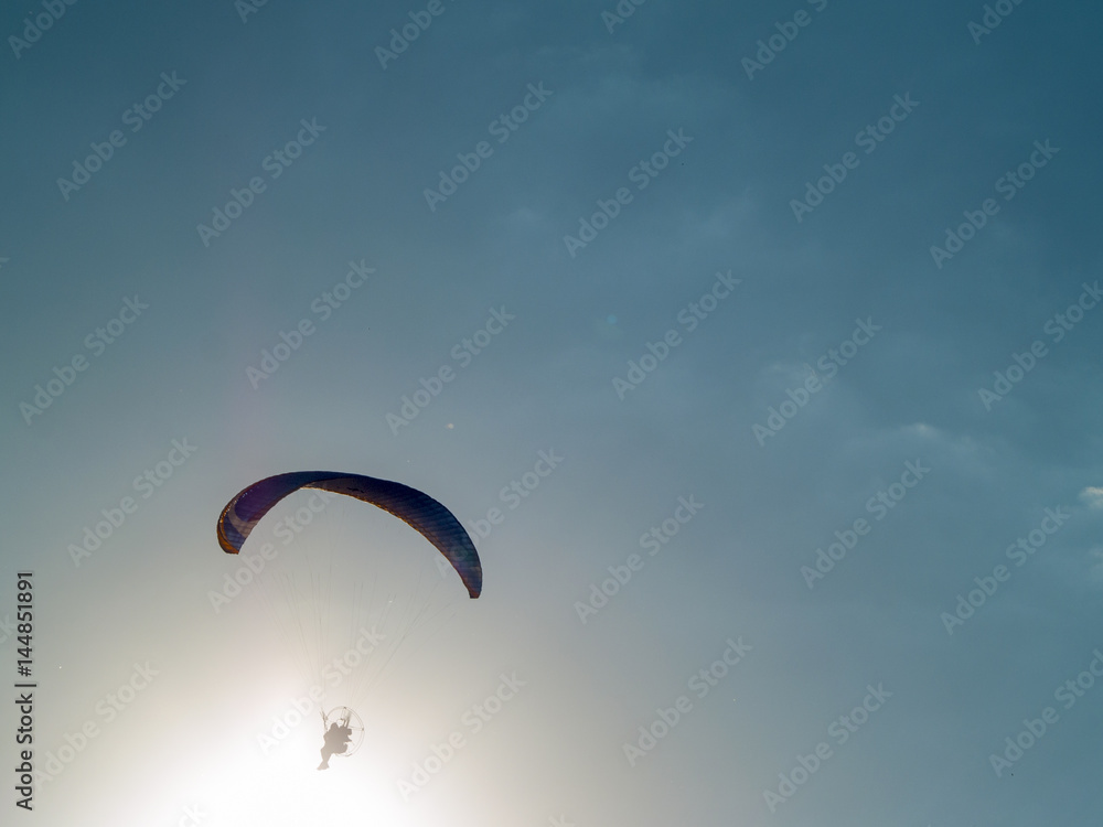A man practicing extreme sport with paraglider with motor A man practicing extreme sport with paraglider with motor