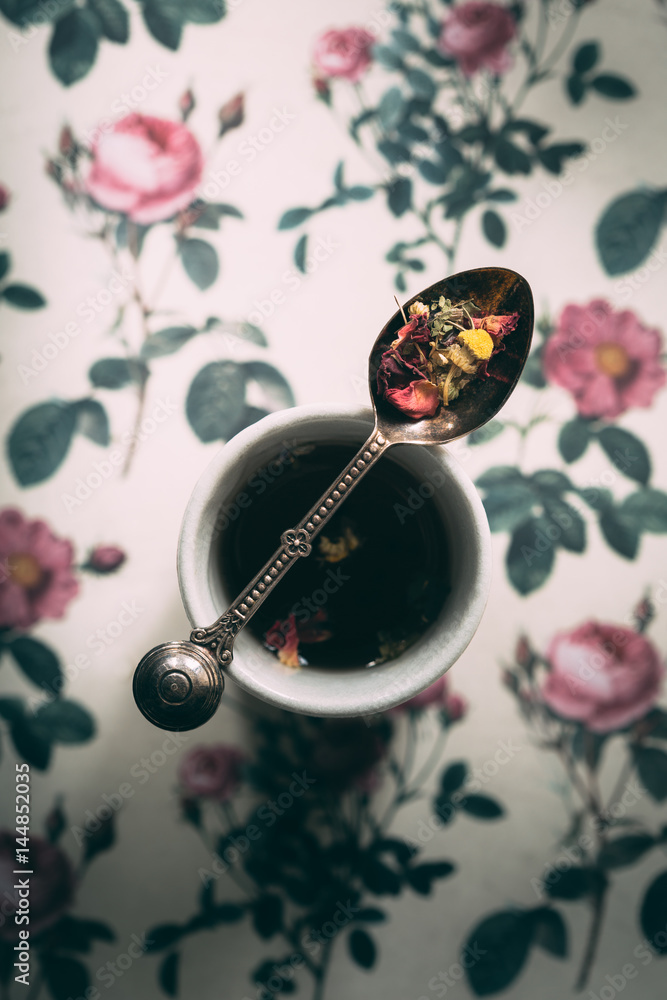 Teaspoon of Herbal Loose Tea resting on Tea Cup Teaspoon of Herbal Loose Tea resting on Tea Cup