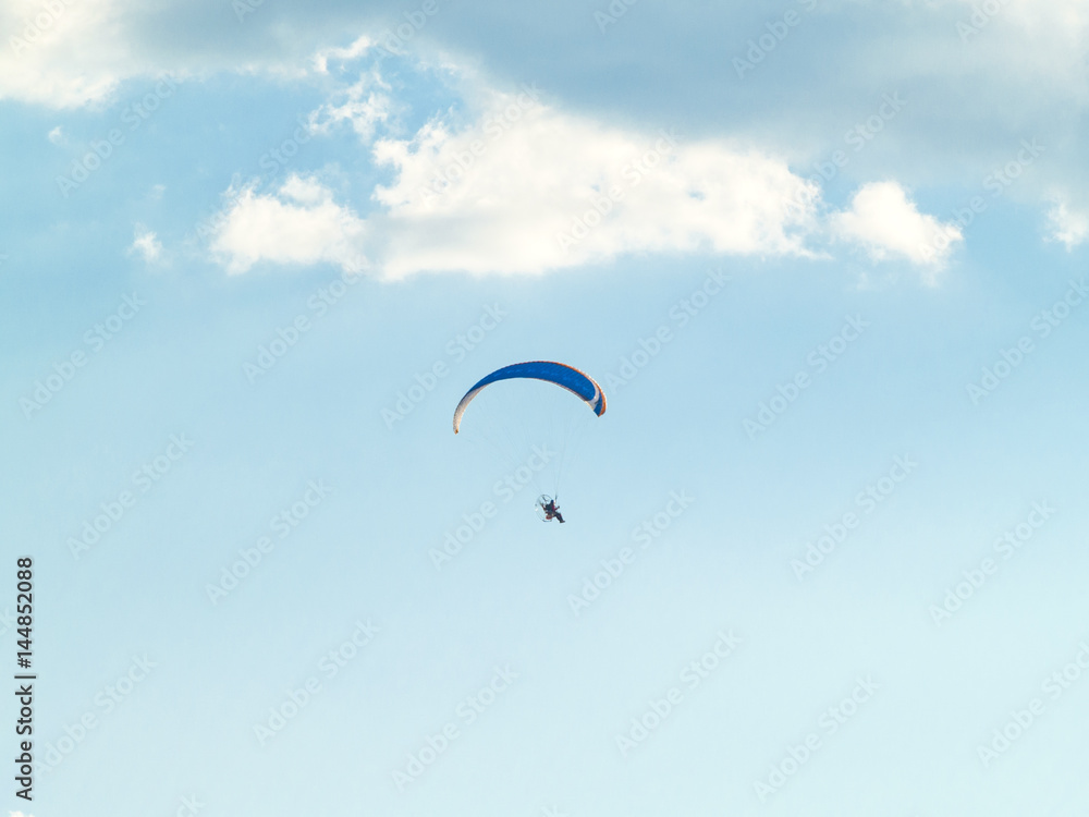 A man practicing extreme sport with paraglider with motor A man practicing extreme sport with paraglider with motor