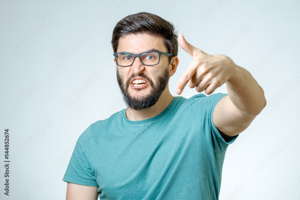 Angry and furious male on a gray background Angry and furious male on a gray background