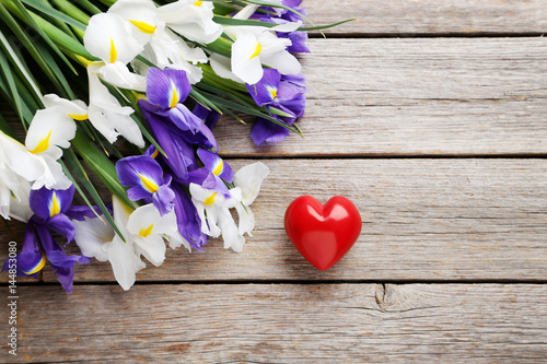 Fototapeta Naklejka Na Ścianę i Meble -  Bouquet of iris flowers with heart on grey wooden table
