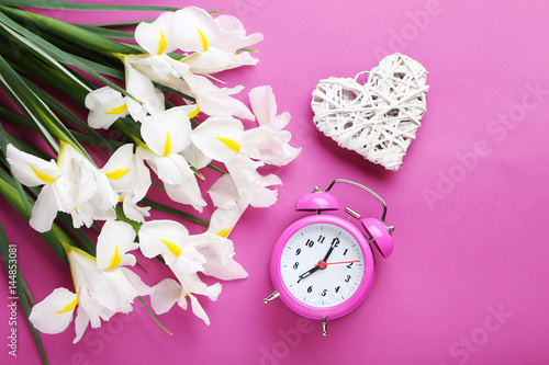 Fototapeta Naklejka Na Ścianę i Meble -  White iris flowers with alarm clock on pink background