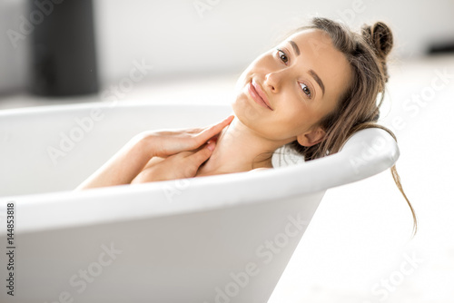 Close-up portrait of a young woman relaxing in the bathtube
