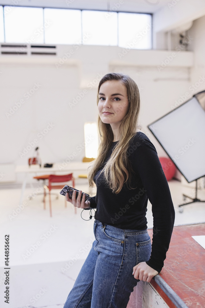 Side view portrait of confident woman standing in office Side view portrait of confident woman standing in office