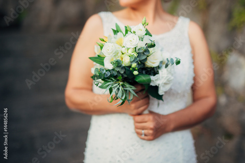 Wedding bouquet in hands of the bride. Wedding in Montenegro