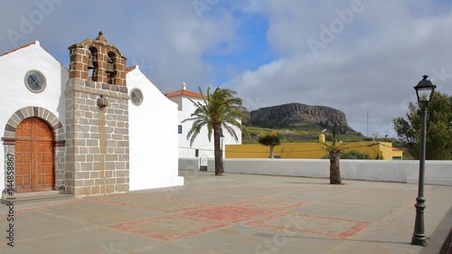 CHIPUDE, LA GOMERA, SPAIN: The church of Chipude (la Iglesia de la Virgen de la Candelaria) with Fortaleza mountain in the background photo