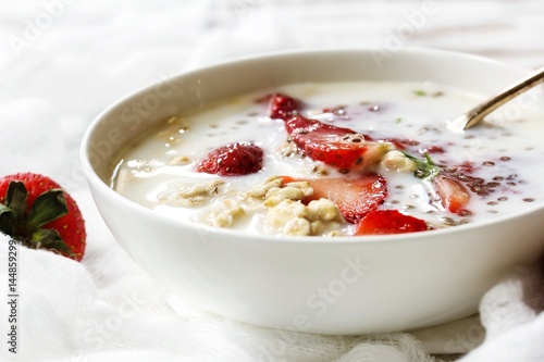 Strawberry Chia overnight oats served in a white bowl, selective focus