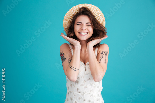 Portrait of a cheerful smiling girl in straw hat
