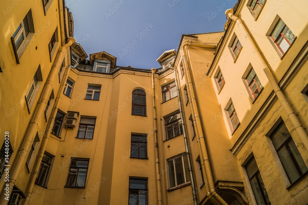 A view of the sky from the well of typical courtyard of old district of St. Petersburg, Russia.


