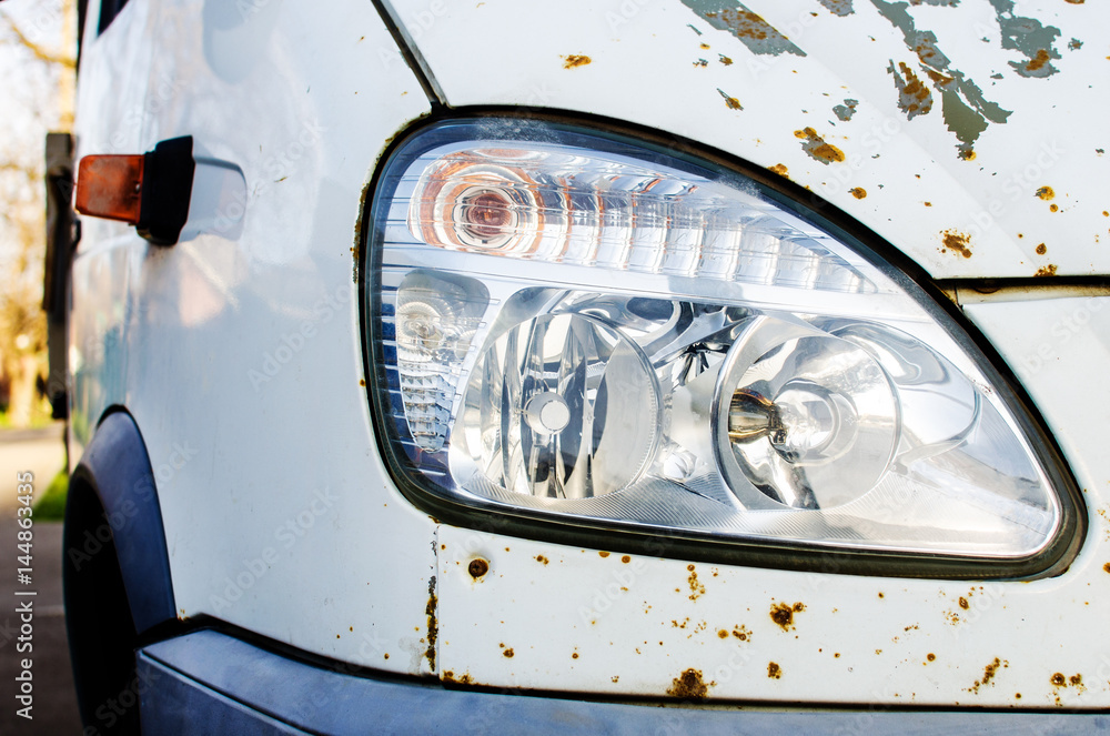 Headlight of an old rusty car
