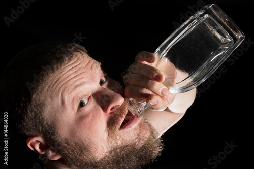 Man holding empty bottle of alcohol