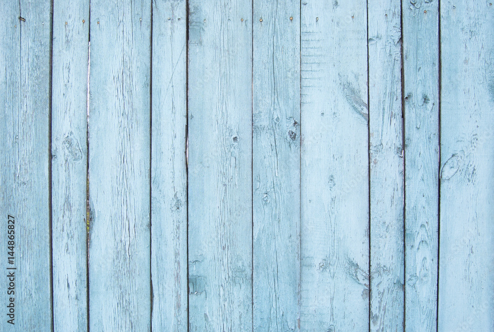 Naklejka premium blue old wooden fence. wood palisade background. planks texture
