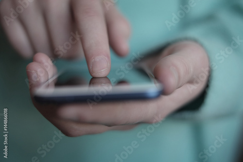 Photography Finger on an Smart Phone Exploring Data