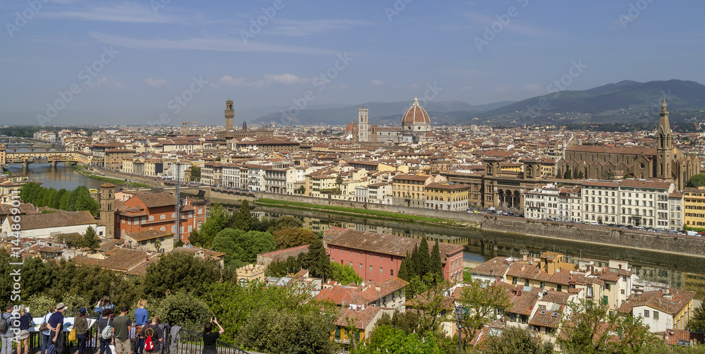 A group of tourists admires the wonderful panorama of the historic center of Florence, Italy, from the terrace of Piazzale Michelangelo