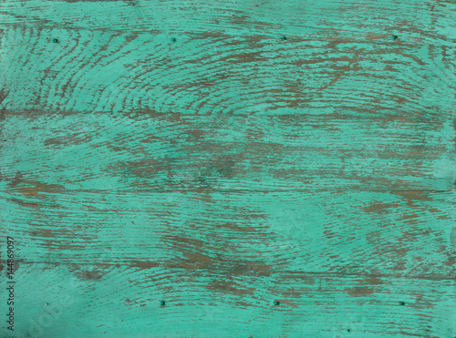 Peeling green paint on a wooden background, old rustic wooden panels, structure and texture of hardwoods