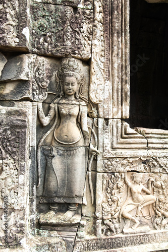 Apsara old stone statue in Bayon temple, Angkor Wat, Siem Reap, Cambodia photo