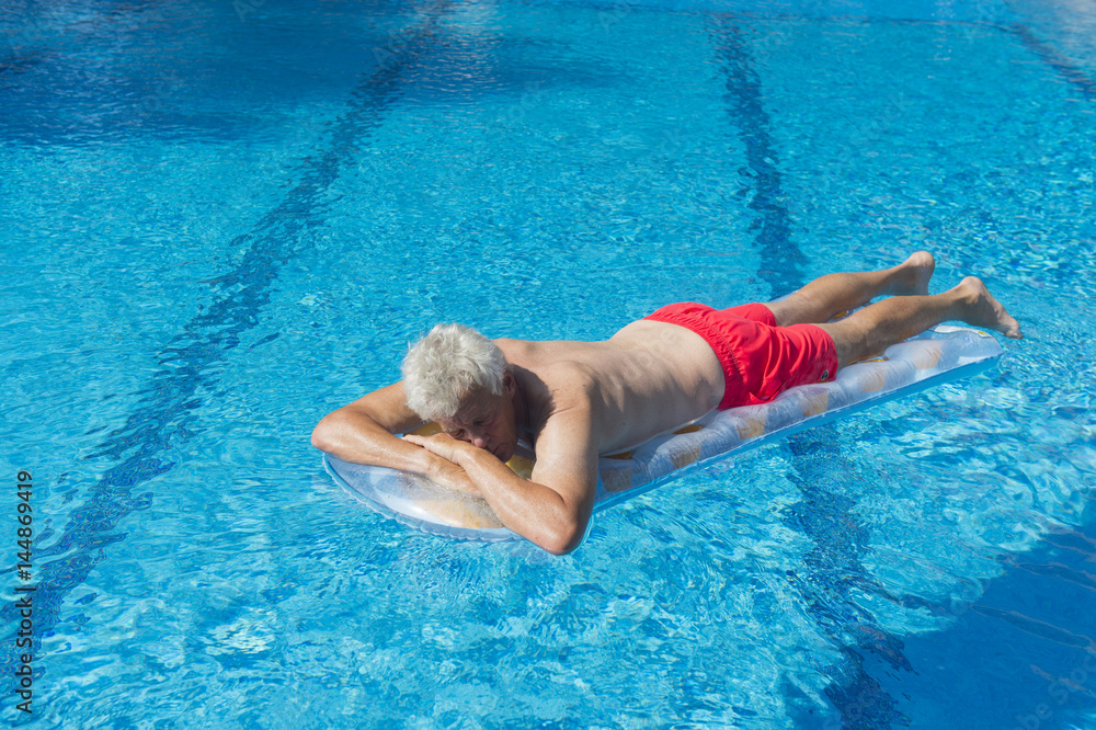 Senior man floating on water