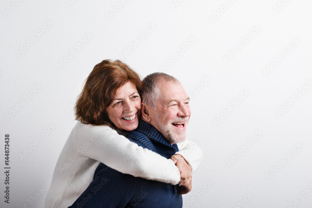 Beautiful senior couple in love hugging. Studio shot. Beautiful senior couple in love hugging. Studio shot.