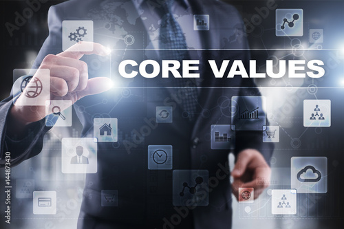 Businessman selecting core values on virtual screen.