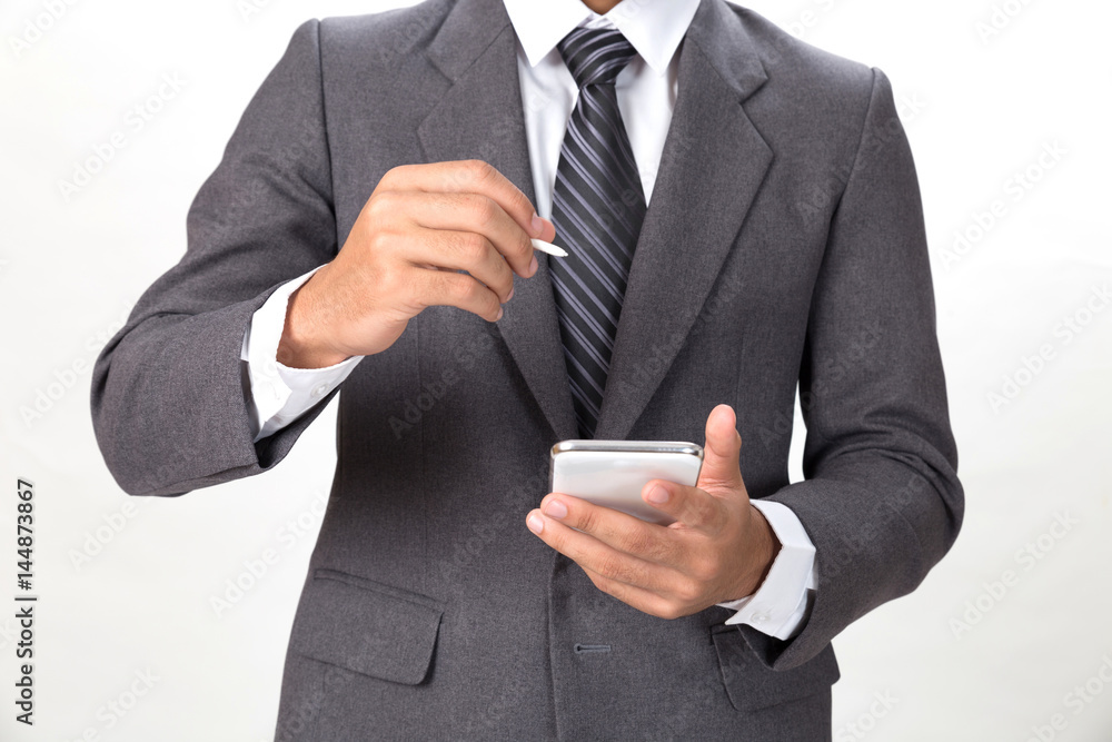 young asian businessman wearing gray suit using mobile smart phone with touch pen over white background young asian businessman wearing gray suit using mobile smart phone with touch pen over white background