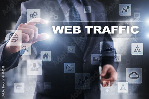 Businessman selecting web traffic on virtual screen.