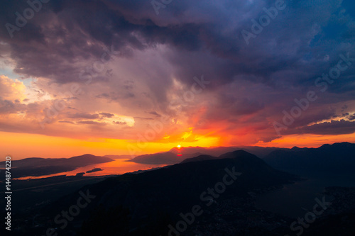 Sunset in Montenegro over the mountains and the sea. Orange sunsets. © Nadtochiy