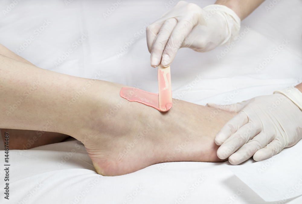 Process depilation female legs and hands in a beauty salon Process depilation female legs and hands in a beauty salon
