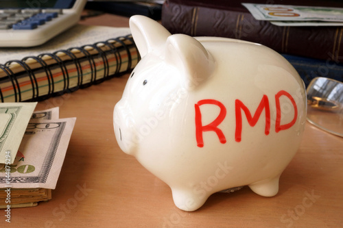Piggy bank with word RMD. Retirement concept. photo